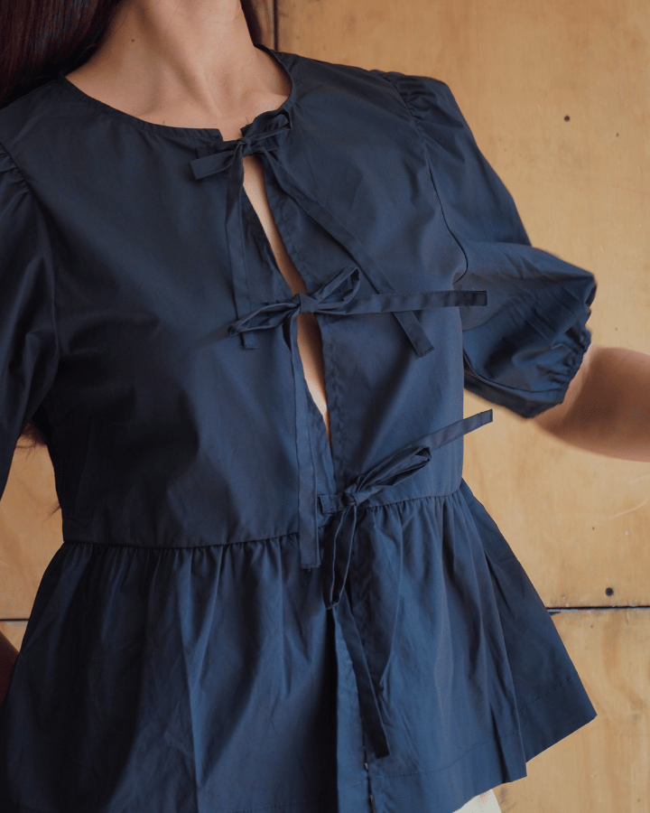 BLUSA AZZURRO CON MOÑOS NEGRO